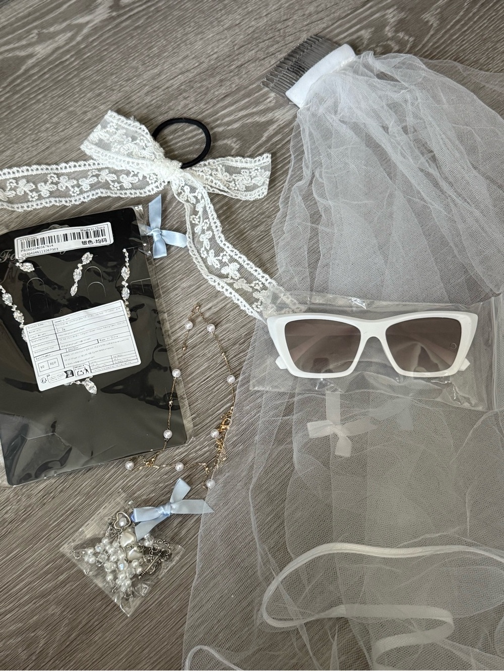 White Bridal Veil with Lace Bow and White Sunglasses and Necklaces